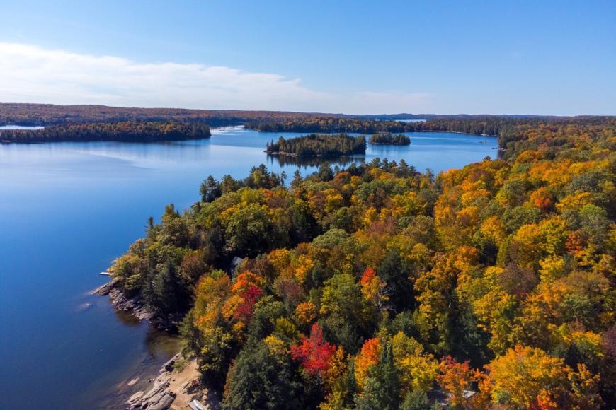 Fall photo of Kennisis Lake showing rocky outcroppings along the shoreline.