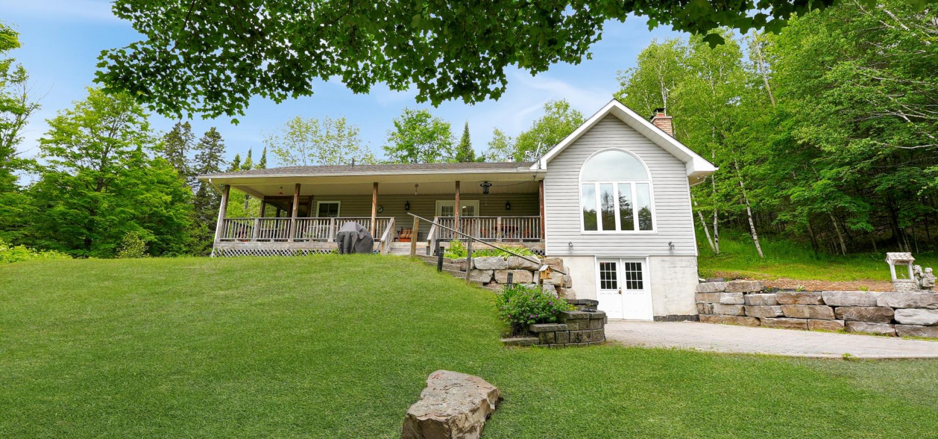 House with Covered porch, with grass leading up to it