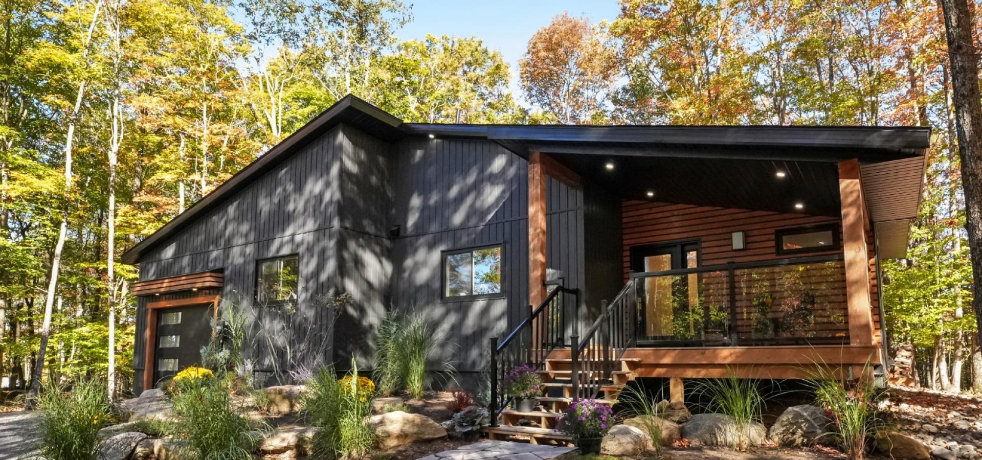 dark grey home with covered front porch and stone walkway