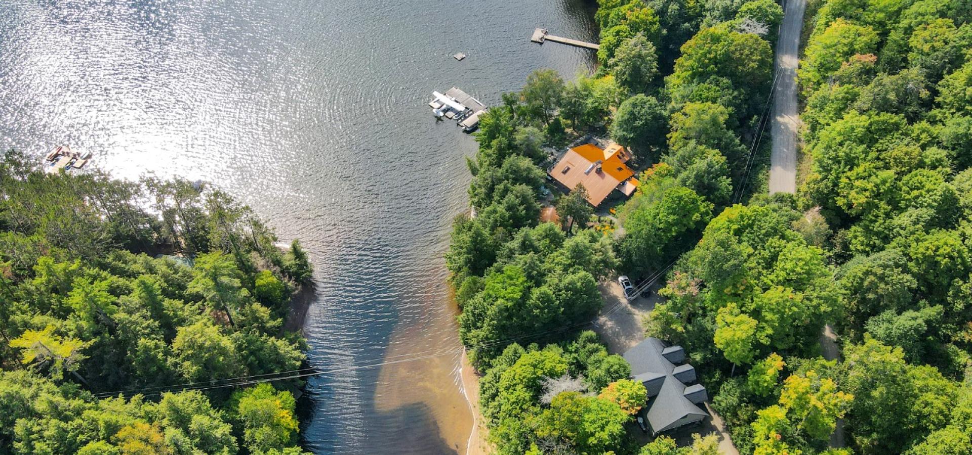 Lakefront property with a dock into the lake. Lakeside house with garage and boat launch.