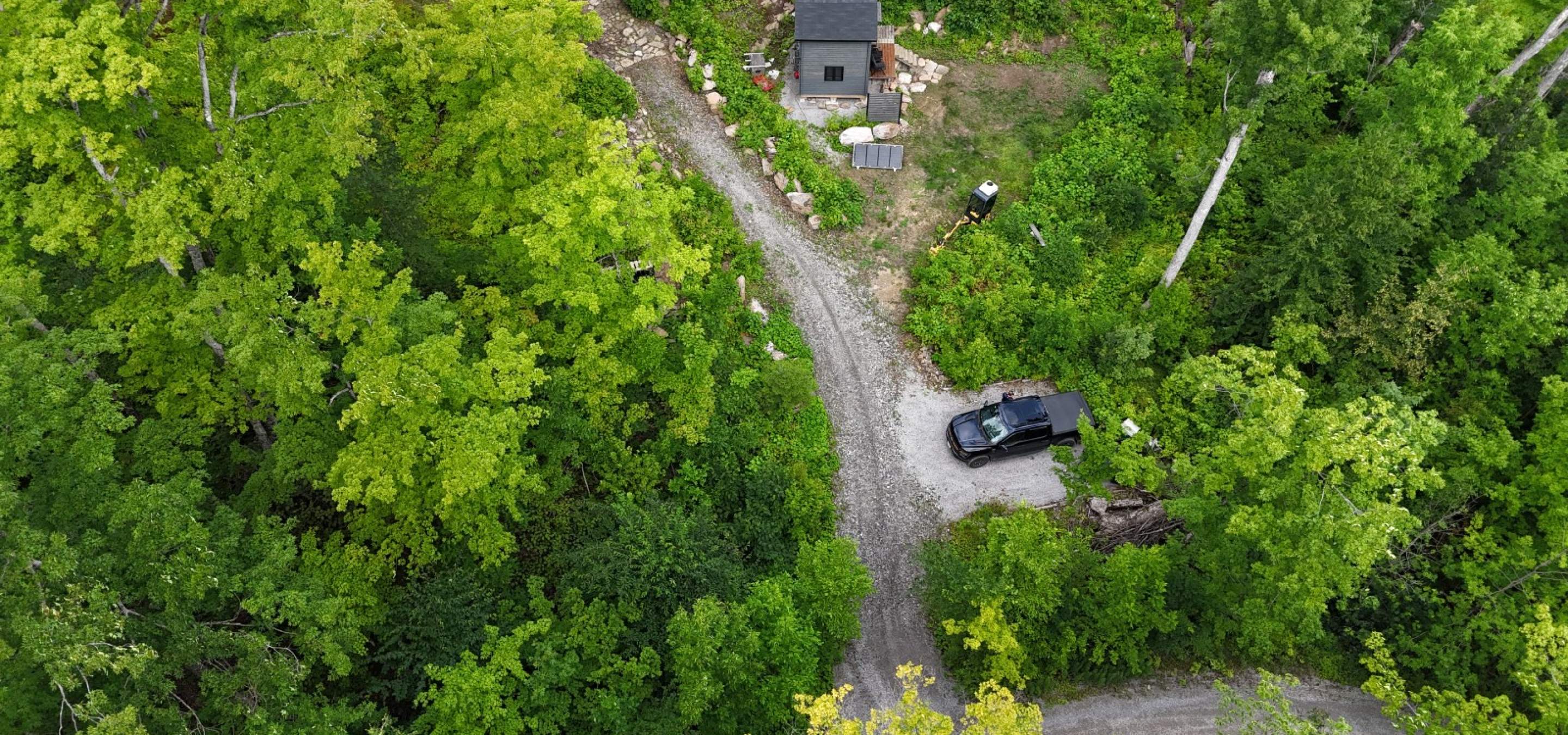 aerial view of a long with grey shed and truck in the laneway