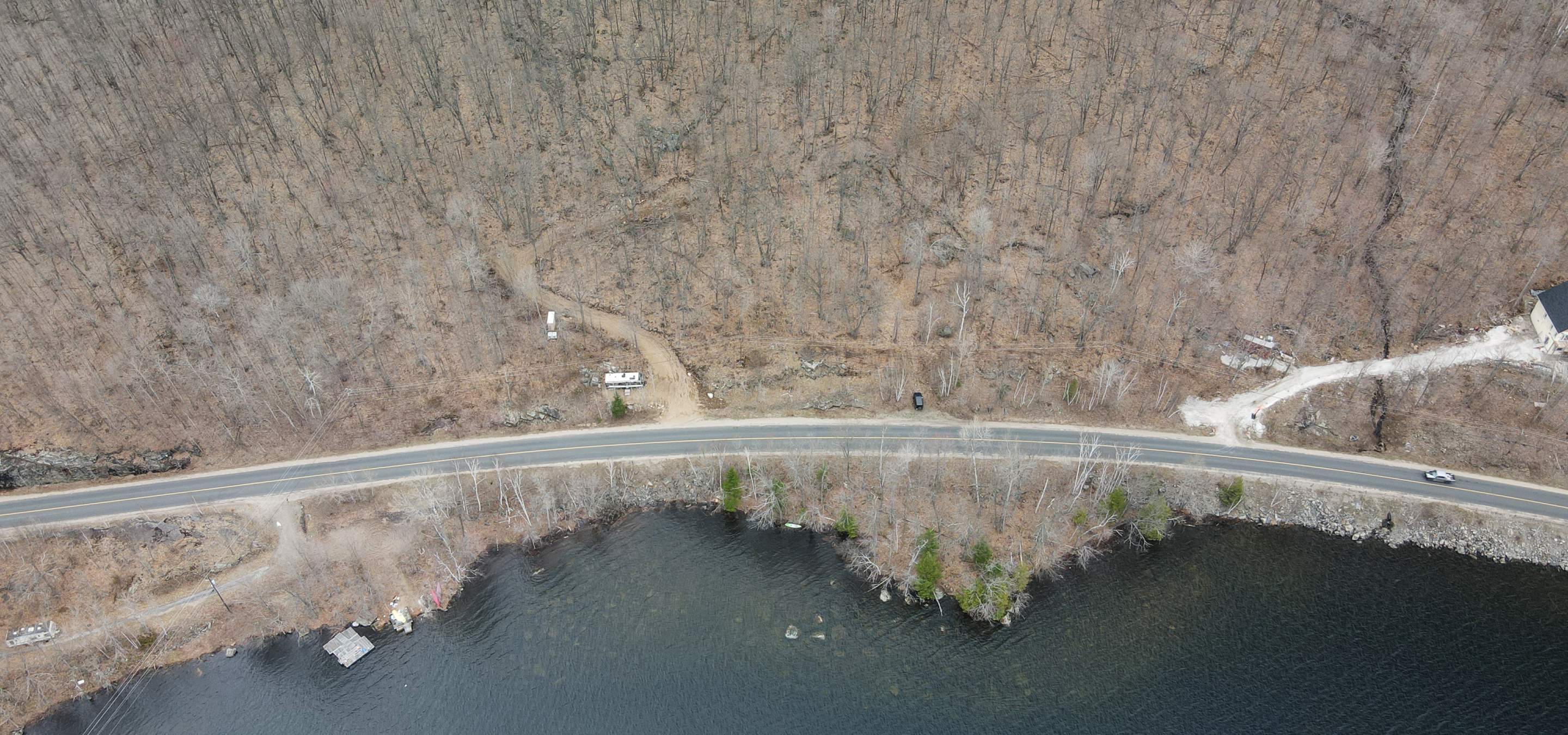 Aerial view of a building lot in front of a lake