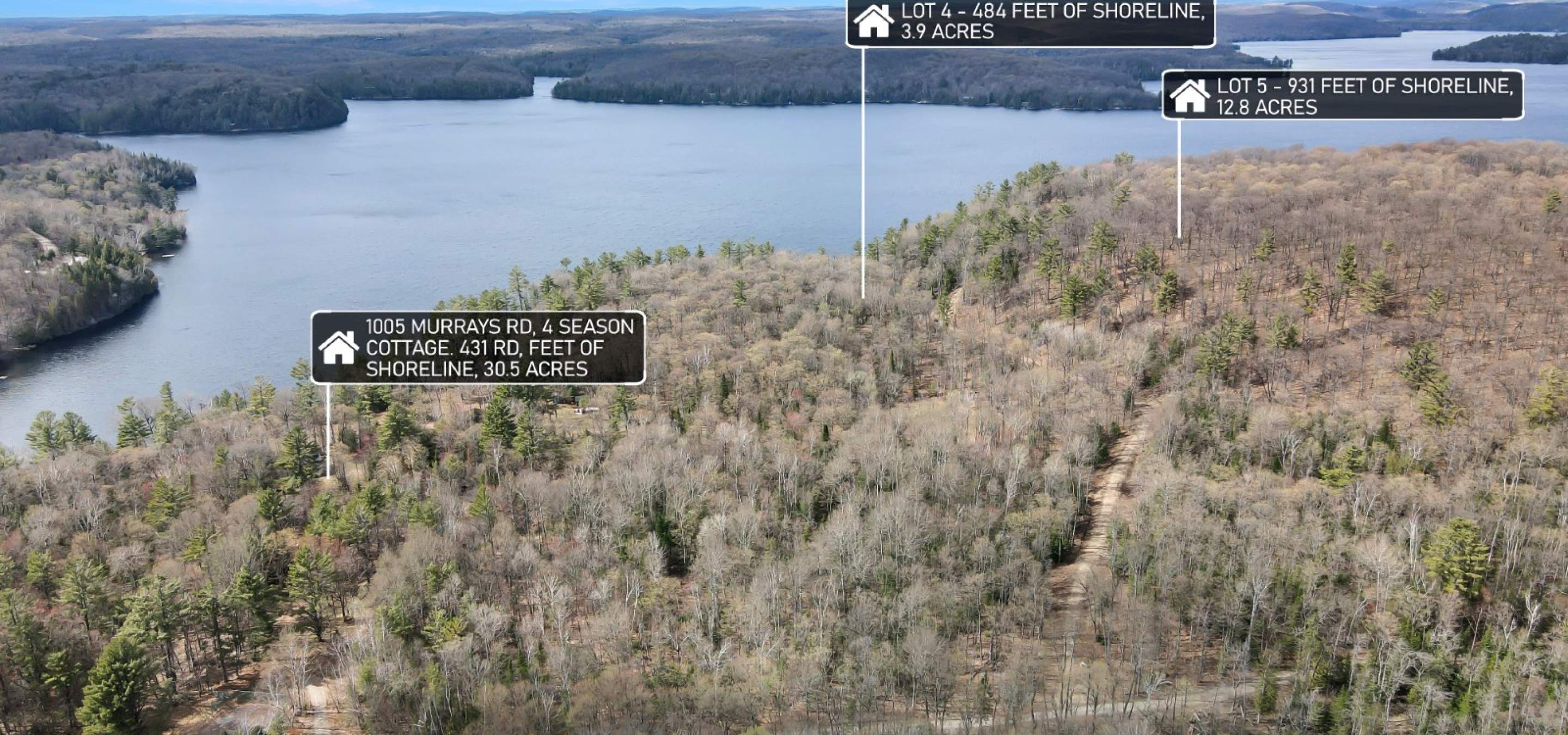 Aerial view of 3 lots with information bubbles and lake in the background