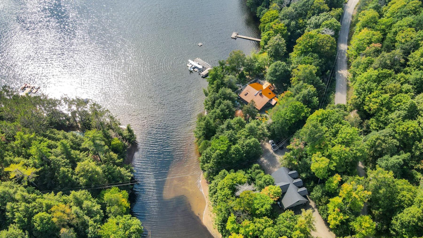 Lakefront property with a dock into the lake. Lakeside house with garage and boat launch.
