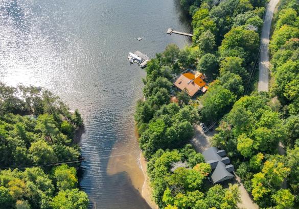 Lakefront property with a dock into the lake. Lakeside house with garage and boat launch.