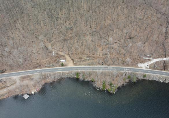 Aerial view of a building lot in front of a lake