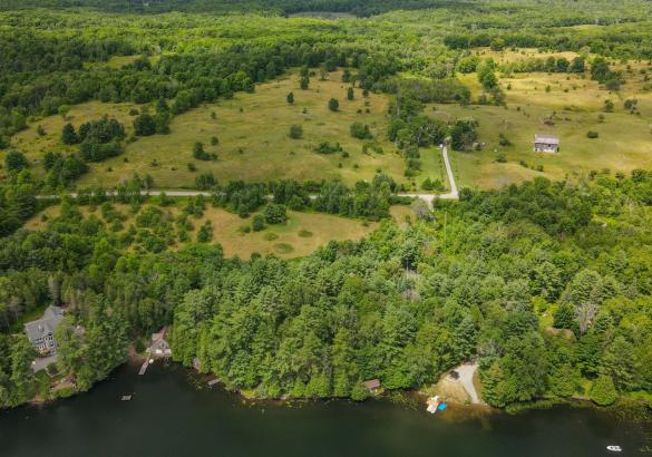92 acres with grass pastures and wooded areas, with a barn and house. 7 acres for building with dock and boat launch